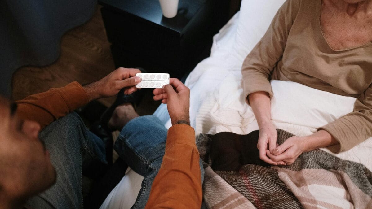 signs and symptoms of caregiver burnout caregiver giving medication to patient